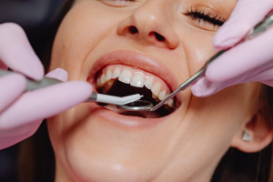 Woman being examined for gum disease treatment