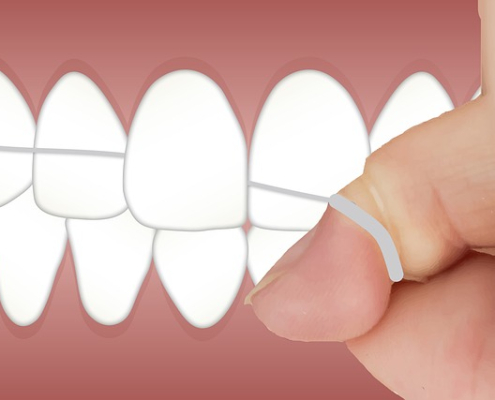 Is flossing important? A person shown flossing their teeth.